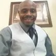 Smiling man in vest and tie.